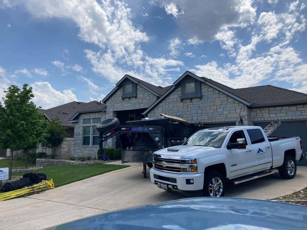 Altitude Roofing crew replacing a roof on a home in the Falcon Point neighborhood of Pflugerville Texas